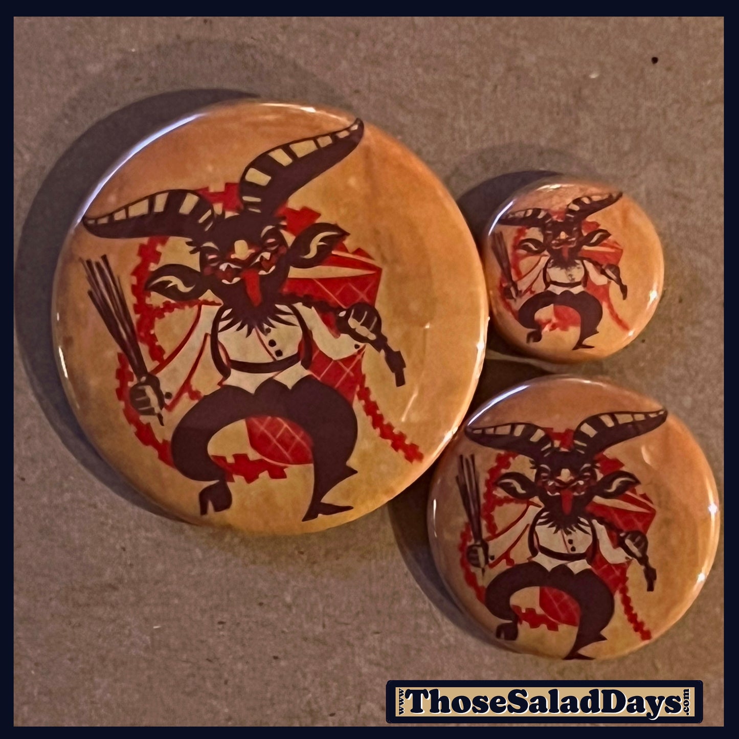 Three buttons of a Krampus Image. One size is 1", 1.5" and 2.25".