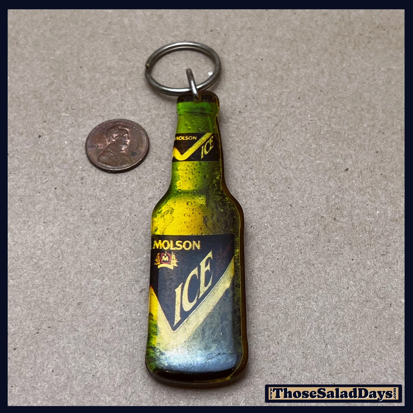 Molson Ice bottle-shaped keychain on a gray background