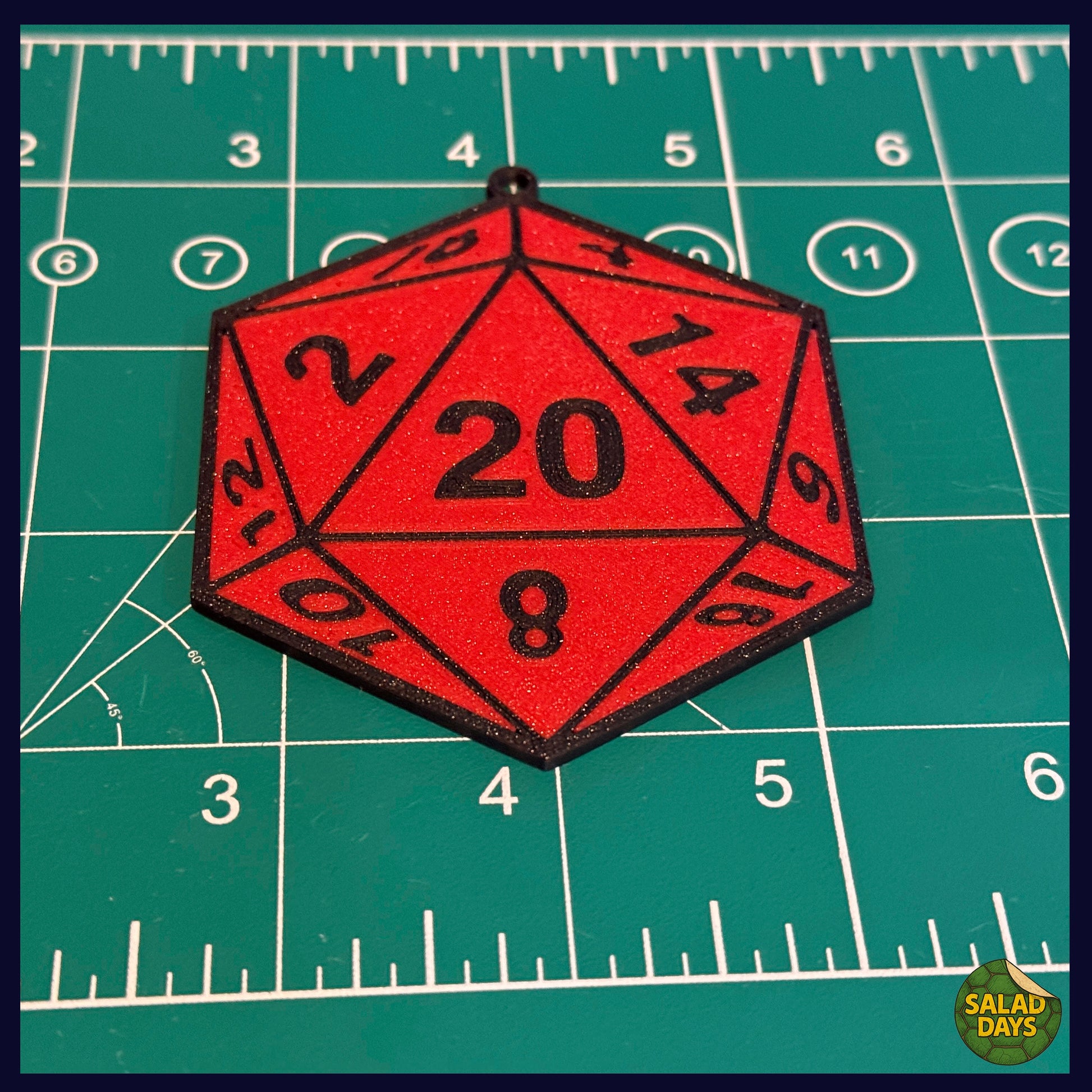 Red polyhedral die with numbers on a green grid background