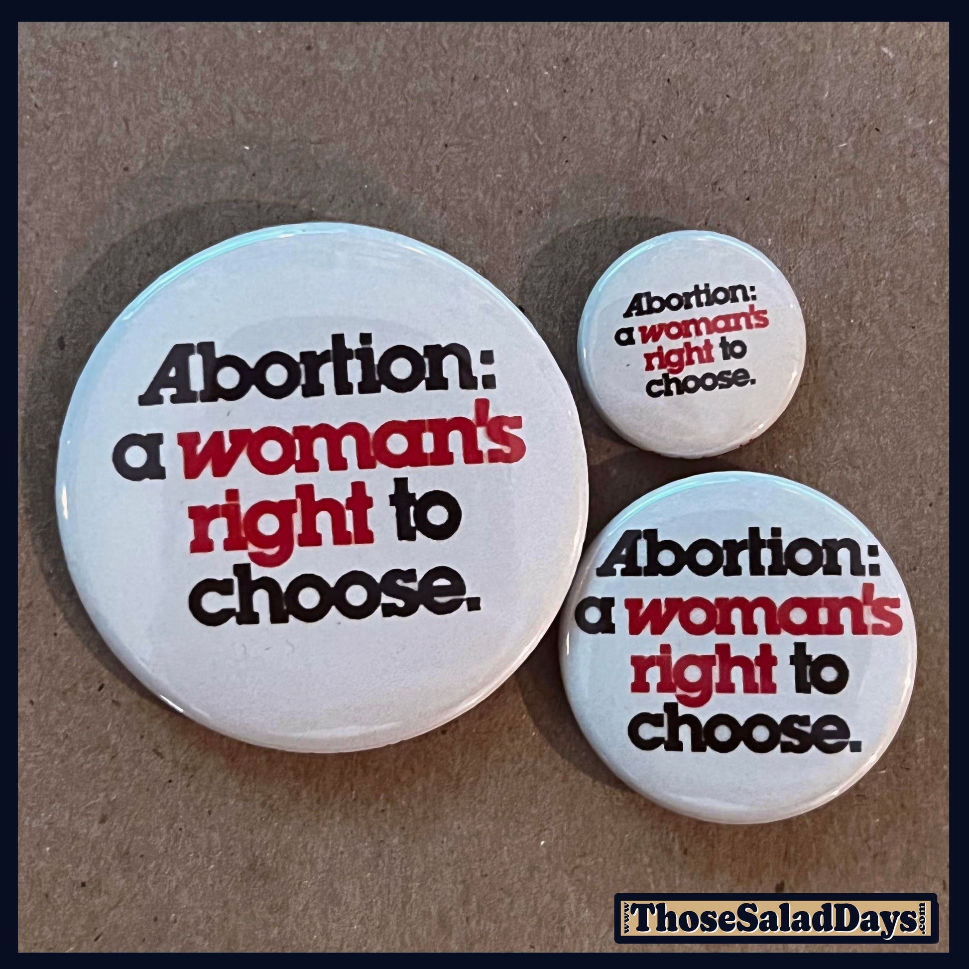 Three buttons with pro-choice text on a brown background