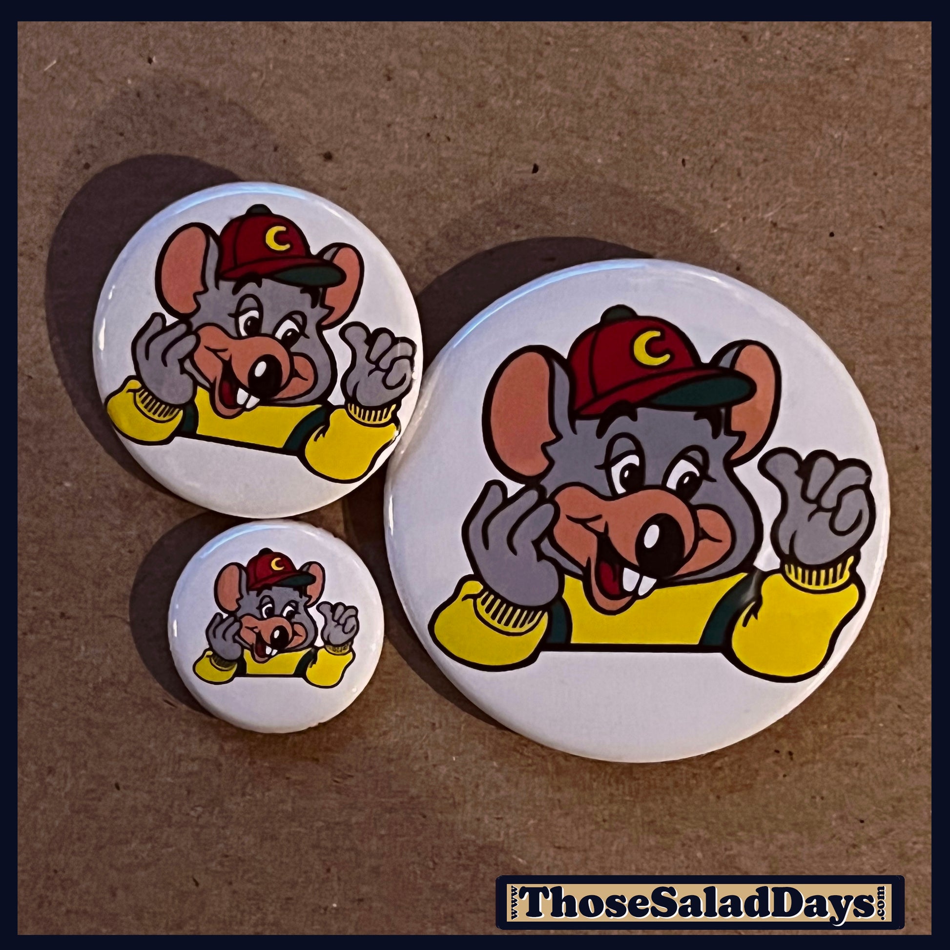 Three buttons with a cartoon mouse character wearing a red cap and yellow jacket on a brown background.