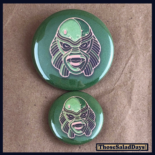 Two buttons of a colorful monster. One size is 1" and the other is 1.5".