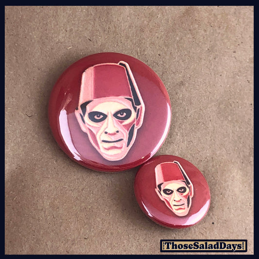 Two buttons of a colorful monster. One size is 1" and the other is 1.5".