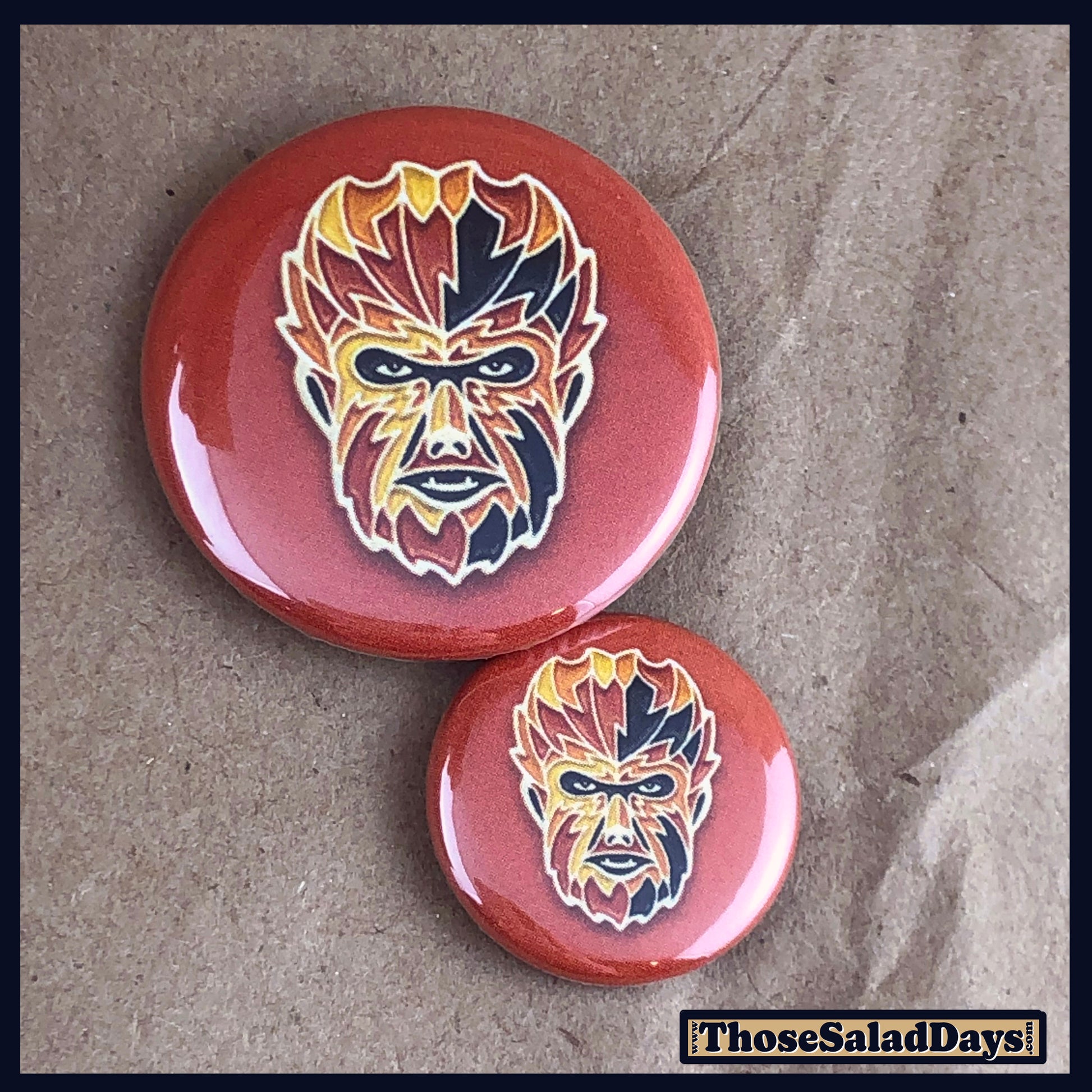 Two buttons of a colorful monster. One size is 1" and the other is 1.5".