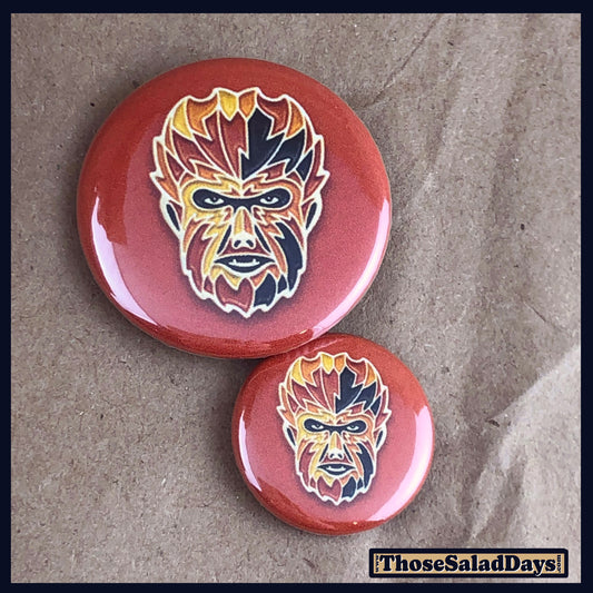 Two buttons of a colorful monster. One size is 1" and the other is 1.5".