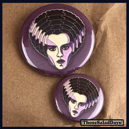 Two buttons of a colorful monster. One size is 1" and the other is 1.5".
