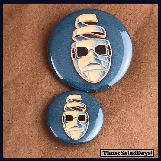 Two buttons of a colorful monster. One size is 1" and the other is 1.5".