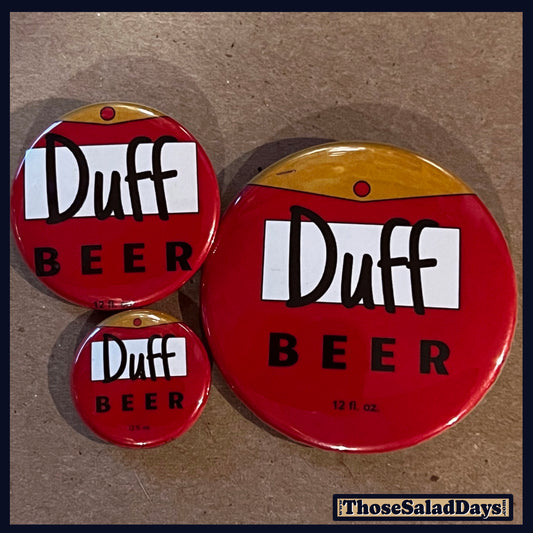 Three 'Duff Beer' buttons on a brown background
