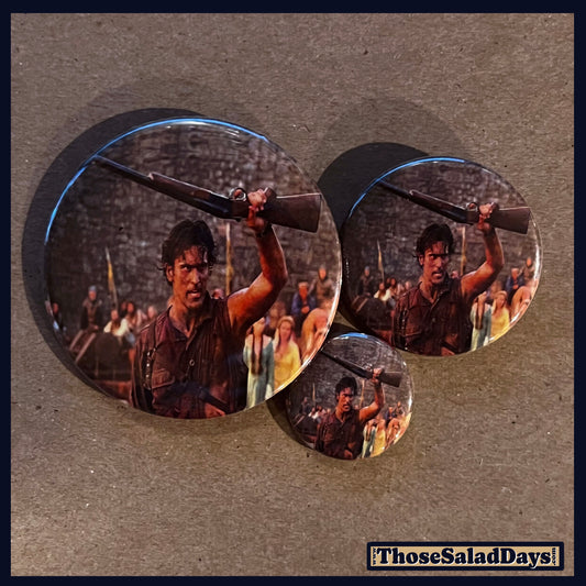 Three buttons of an Evil Dead type image. One size is 1", 1.5" and 2.25".