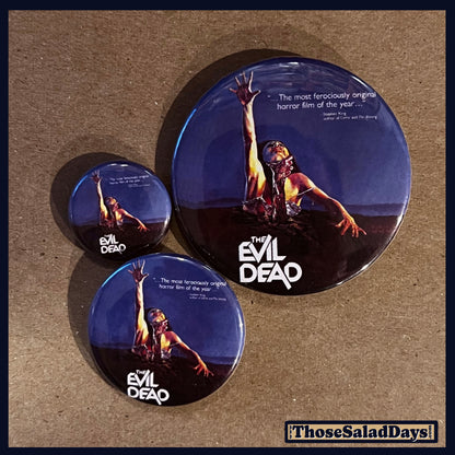 Three buttons of an Evil Dead type image. One size is 1", 1.5" and 2.25".