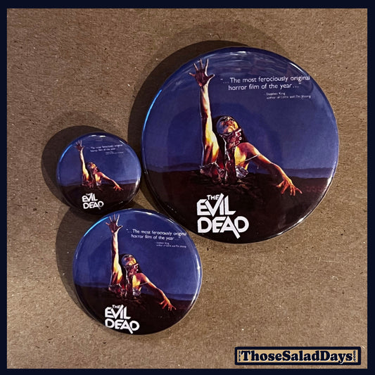Three buttons of an Evil Dead type image. One size is 1", 1.5" and 2.25".