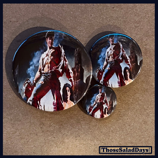 Three buttons of an Evil Dead type image. One size is 1", 1.5" and 2.25".
