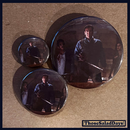 Three buttons of an Evil Dead type image. One size is 1", 1.5" and 2.25".
