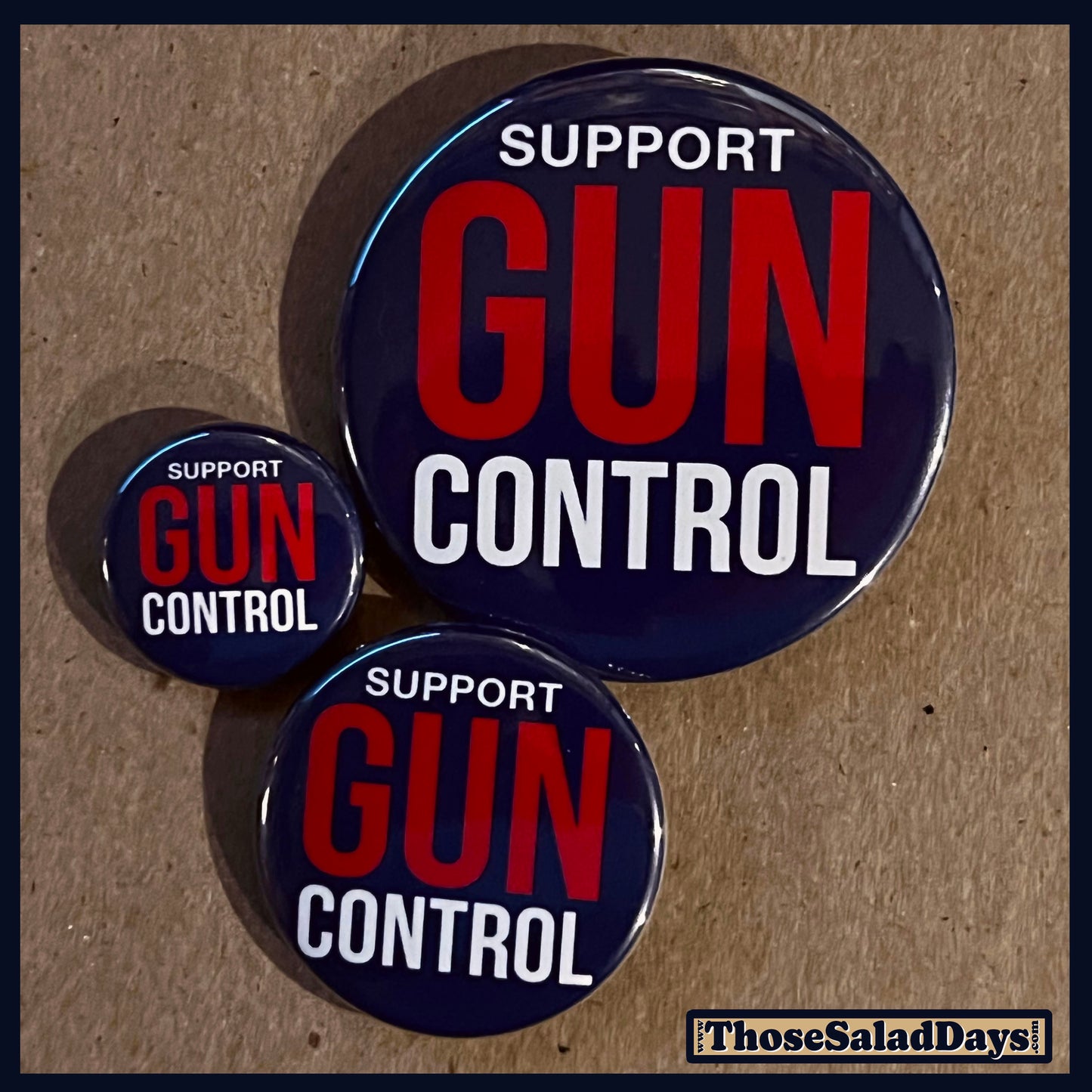 Three buttons of a Gun Reform Message. One size is 1", 1.5" and 2.25".