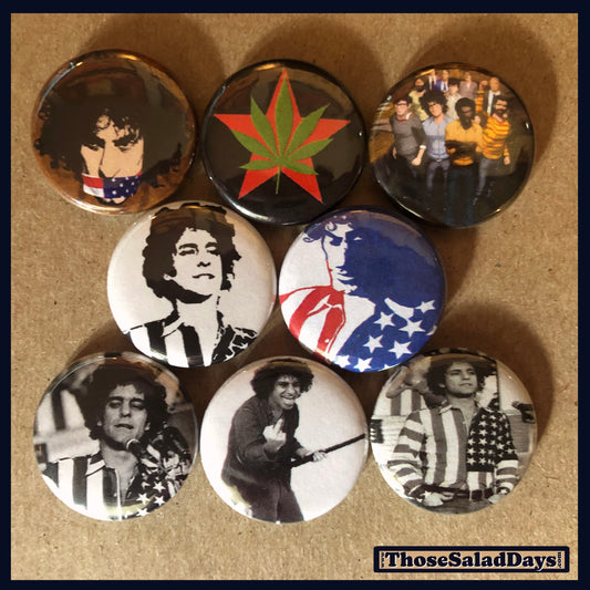 Collection of buttons with various Yippie! designs on a brown background