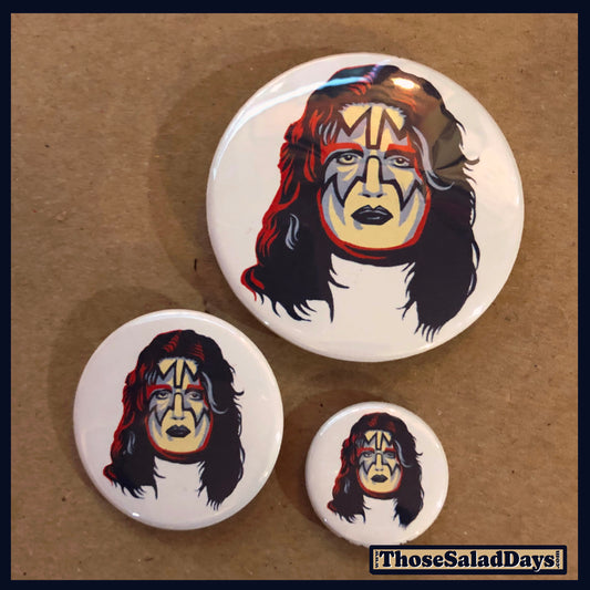 Three buttons of Artistic KISS. One size is 1", 1.5" and 2.25".