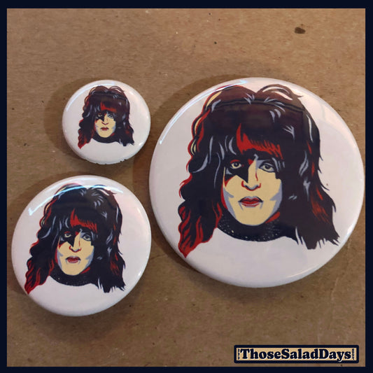 Three buttons of Artistic KISS. One size is 1", 1.5" and 2.25".