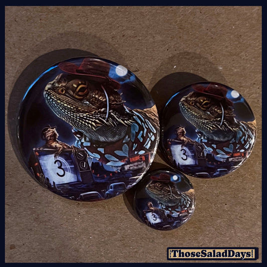 Three buttons of a Last Drive-In Image. One size is 1", 1.5" and 2.25".