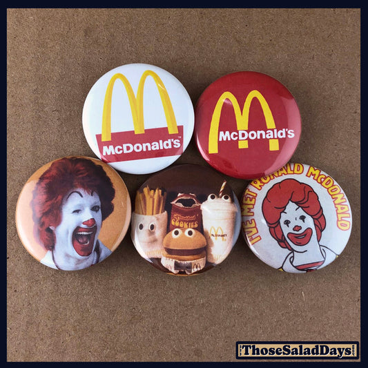 Set of buttons featuring images of McDonalds on a brown background.