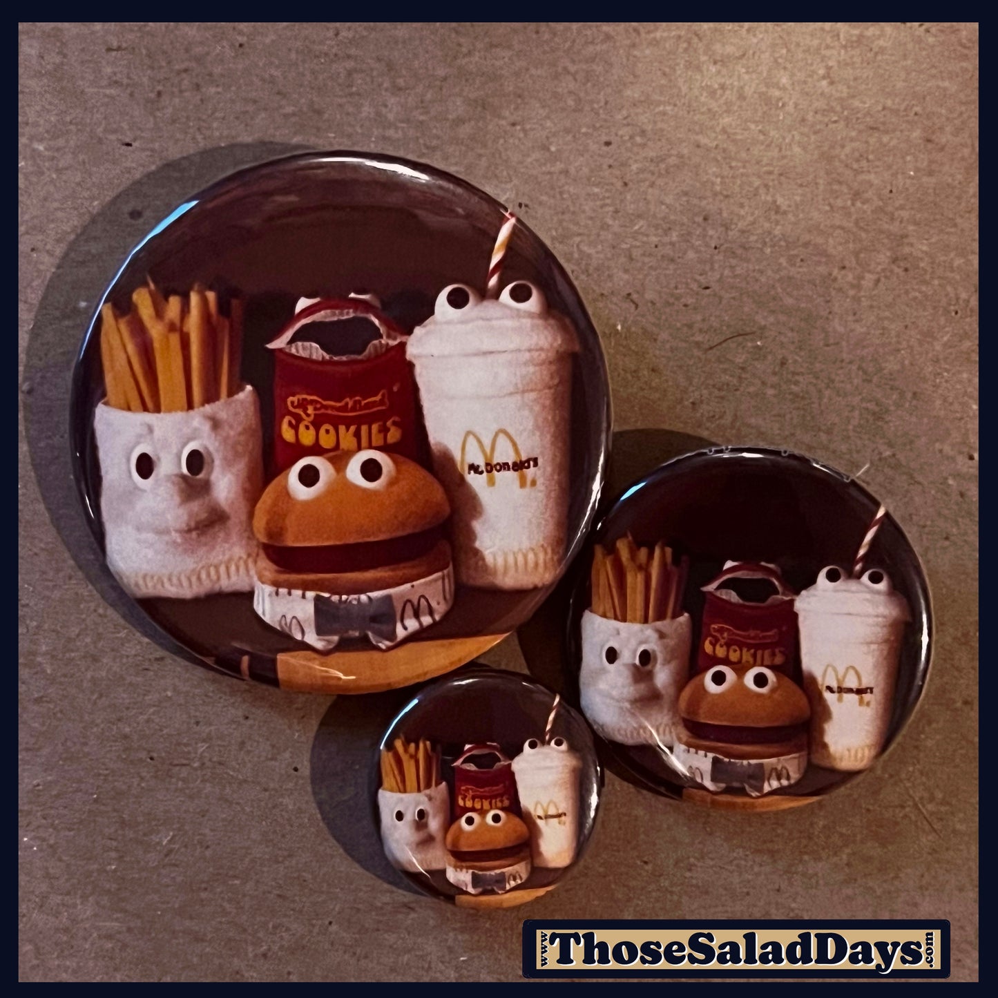 Set of three round pins with cartoonish food items from McDonalds