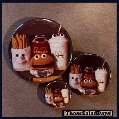 Set of three round pins with cartoonish food items from McDonalds