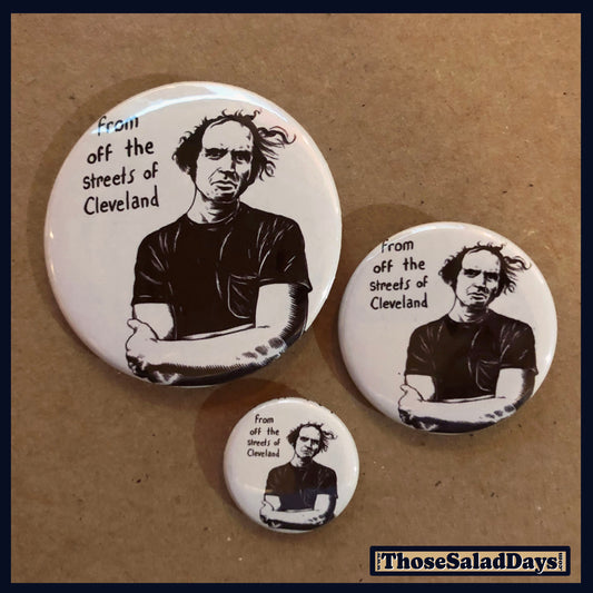Three buttons with a black and white illustration of a man and text 'From off the streets of Cleveland' on a brown background.