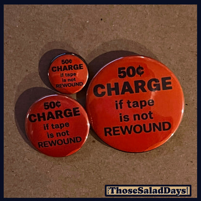 Three reddish buttons with black text on a brown background, featuring the phrase '50¢ Charge if tape is not Rewound'.