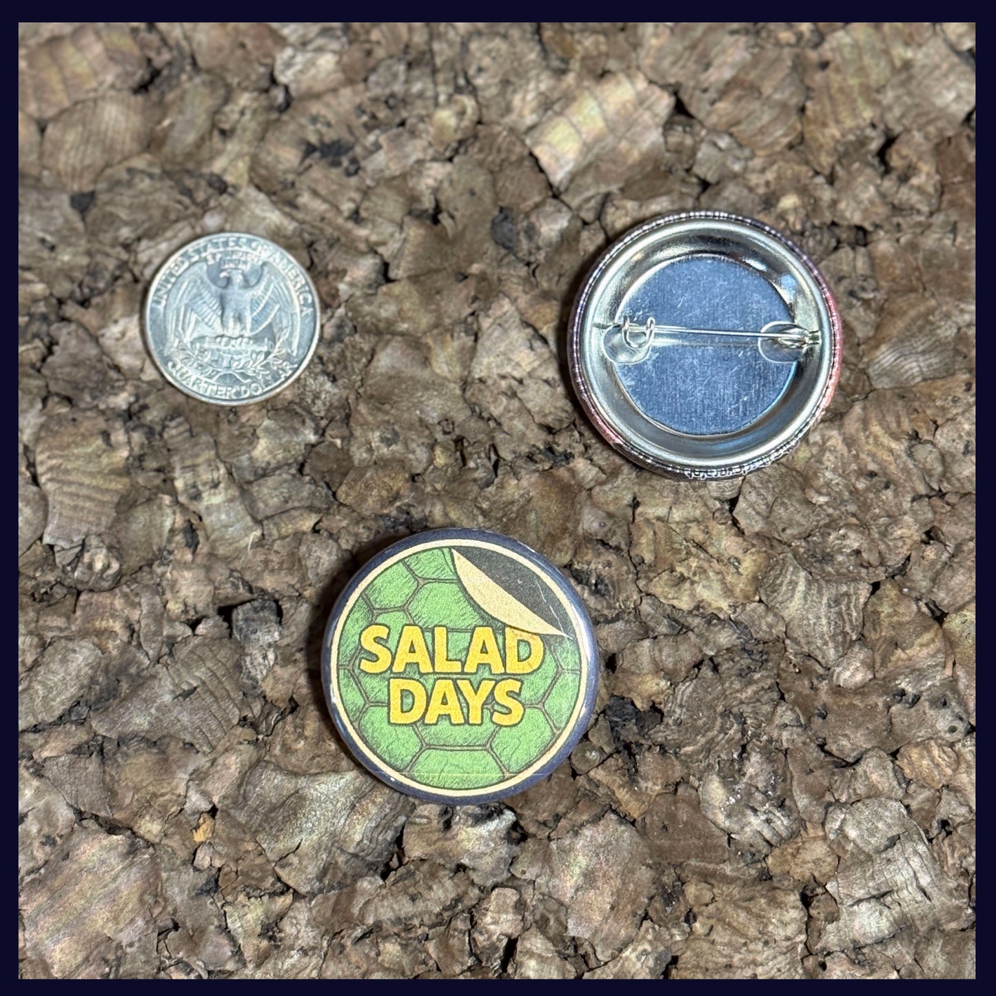 Two buttons on a textured surface with a quarter for scale. Showing the size of the button is 1.5 Inches.