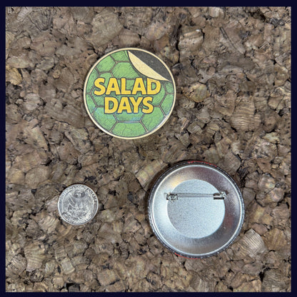 Two buttons on a textured surface with a quarter for scale. Showing the size of the button is 2.25 Inches.