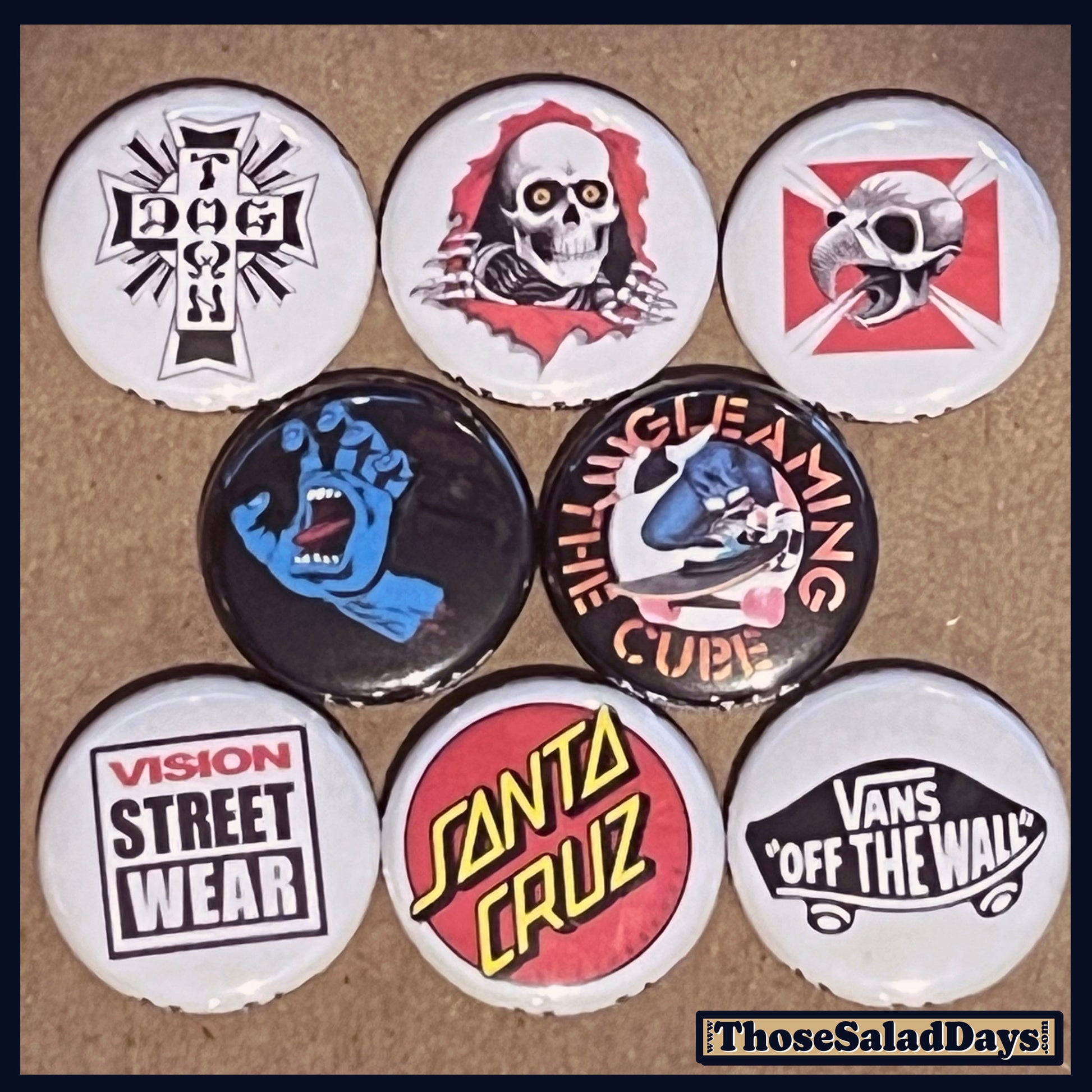 Set of buttons with various skateboard designs on a brown background