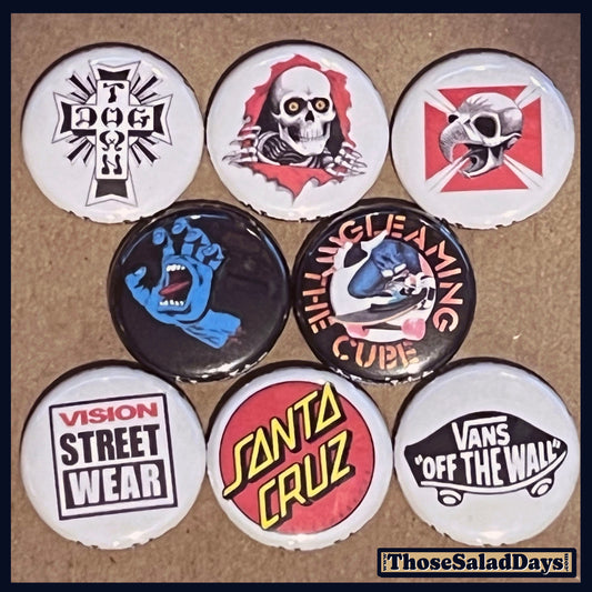 Set of buttons with various skateboard designs on a brown background