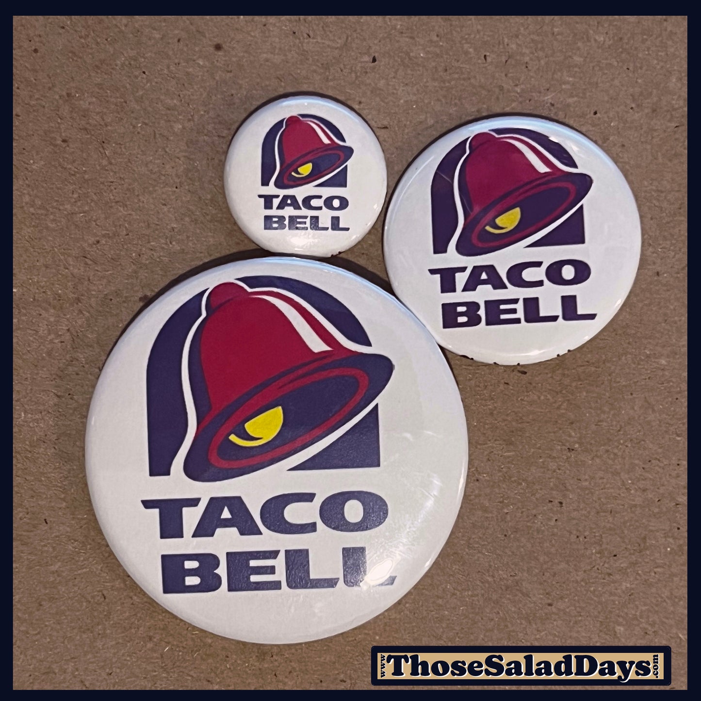 Three Taco Bell buttons on a brown background