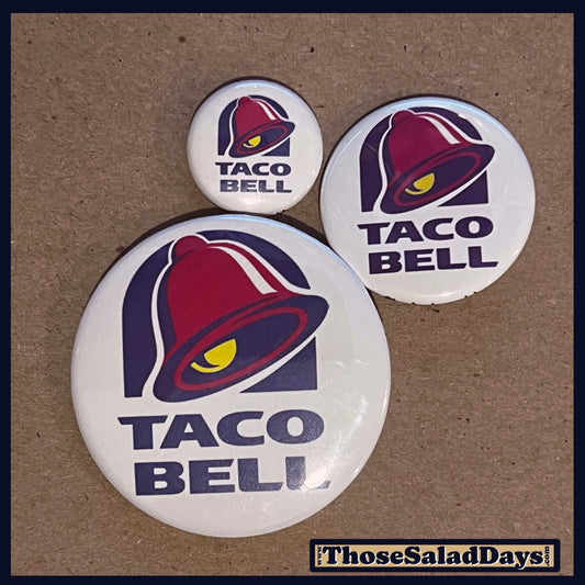 Three Taco Bell buttons on a brown background