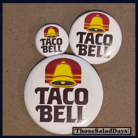 Three Taco Bell buttons on a brown background